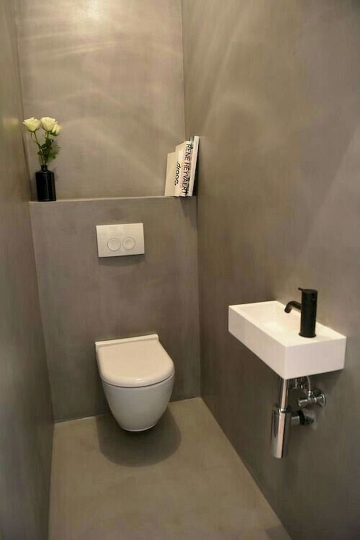 The interior of a small toilet with a conventional toilet